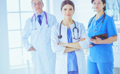 Group of doctors and nurses standing in the hospital room