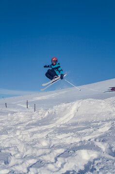 young boy is jumping over a small kicker