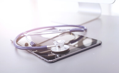 Fototapeta na wymiar Medical equipment: blue stethoscope and tablet on white background