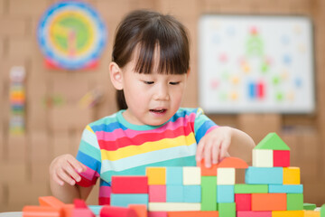 Fototapeta na wymiar young girl playing creative toy blocks for homeschooling