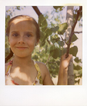 Polaroid Portrait Of A Girl Climbing A Tree In The Summer Sun
