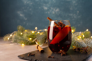 Christmas hot drink-Mulled wine with oranges,cinnamon,anise stars and cloves spice on festive...