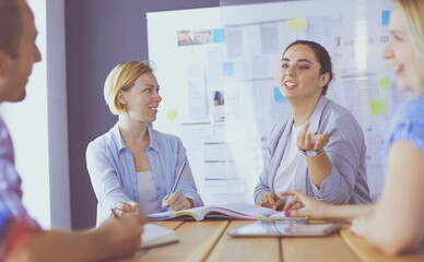 Young people studying with books on desk. Beautiful women and men working together