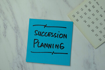 Succession Planning write on sticky notes isolated on office desk.