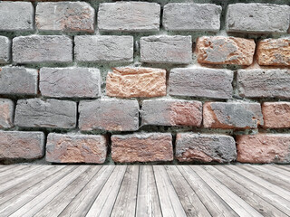 Room interior with rough brick wall and wood floor background.
