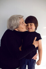 funny grandson in a black t-shirt stands