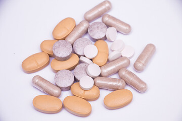 Obraz na płótnie Canvas Mix of pills capsules supplements on white background