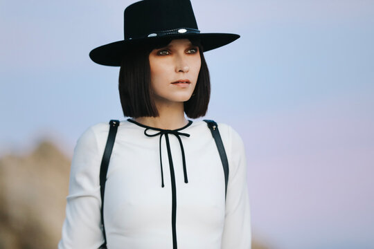 Girl in a white dress and cowboy hat at El Matador Beach