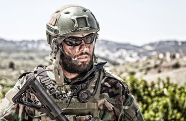 Shoulder portrait of army soldier, special forces fighter, modern warfare combatant with dirty,...