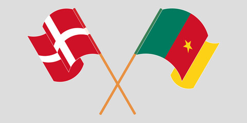 Crossed and waving flags of Cameroon and Denmark