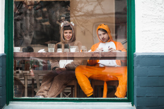 Bear and Kangaroo having breakfast in a cafe window