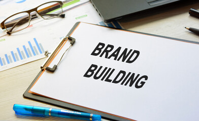 The inscription on business subjects on a white blank lying on the desktop with equipment. Business concept.