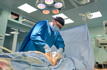 Team surgeon at work in operating room.