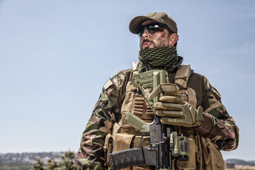 Shoulder portrait of commando fighter, professional mercenary or special forces shooter with dirty...