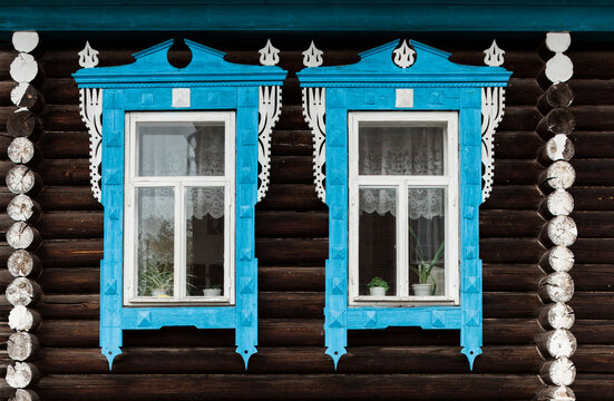 old Russian wooden contry house with blue decorated windows