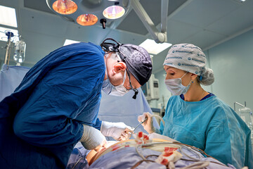 Team surgeon at work in operating room.