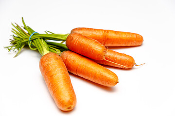 Fresh carrots lying on a white background, isolated.