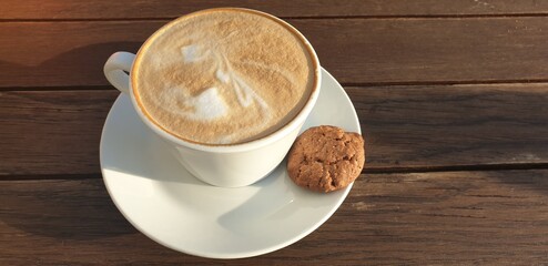 Cup of cappuccino on a wooden table
