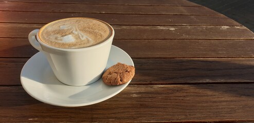 Cup of cappuccino on a wooden table