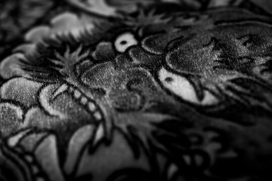 Black and White detail of a complex traditional Japanese backpiece tattoo