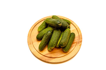 Fresh cucumbers lying on a wooden Board on a white background, isolated.