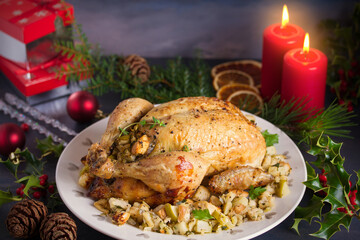 Roasted chicken stuffed with apple bread and celery. Christmas dinner table
