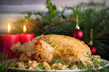 Roasted chicken stuffed with apple bread and celery. Christmas dinner table