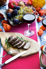 thanksgiving table with meat and fresh autumn fruits and vegetables