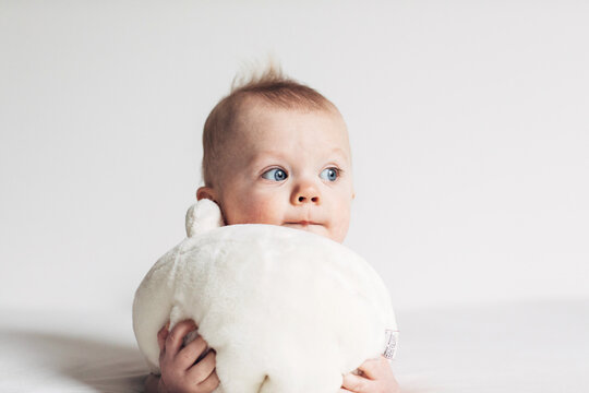 baby hugging his bear