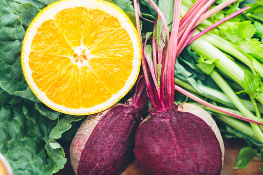 Sliced orange and beetroot on green leaves