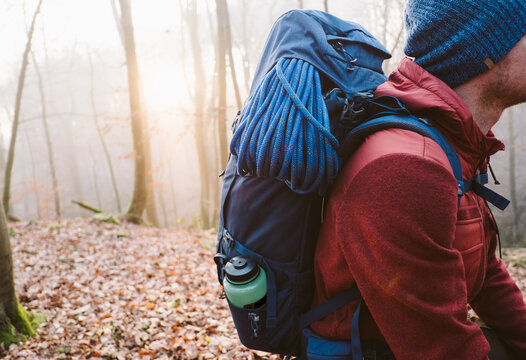 Geared up man hiking having a break in the forest.