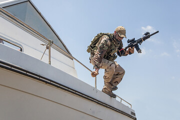 Army commando, special forces soldier equipped with body armour and battle helmet with radio...