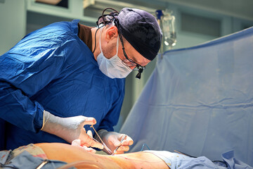 Team surgeon at work in operating room.