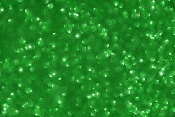 Glamor green sparkling background. Blured glitter background. 