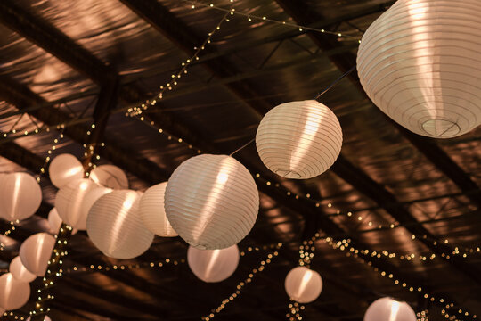 barn decorated for a part with lanterns and fairy lights