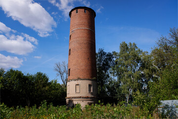 Old water surge brick tower in Pavelets, Russia. Sunny summer view.