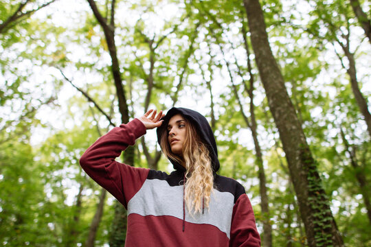 Portrait of woman in the forest between trees