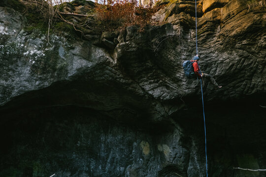 A man abseiling down a cliff.