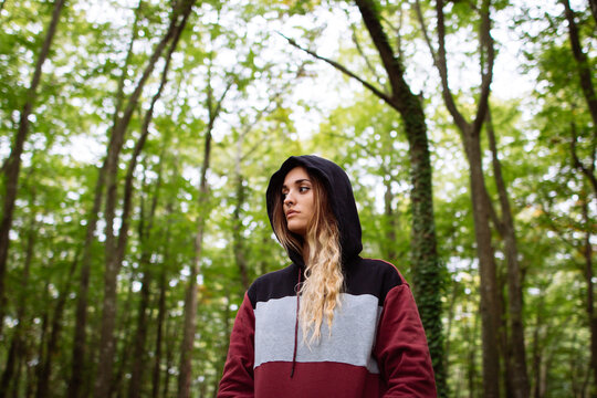 Portrait of woman in the forest between trees