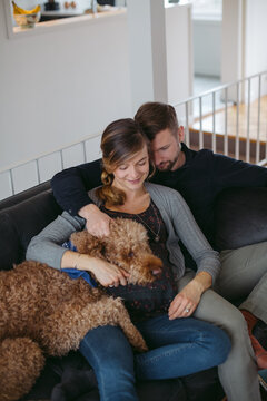 Happy young expecting caucasian couple hanging out at home - cud