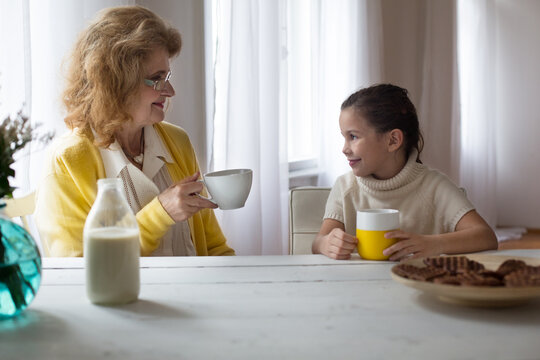Grandma and Granddaughter Having Breakfast
