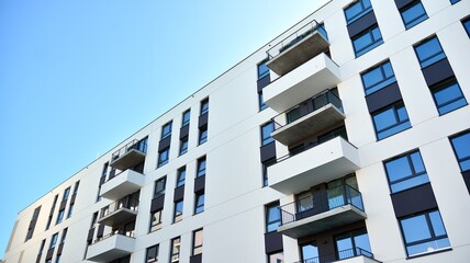 Architectural details of modern apartment building. Modern european residential apartment building complex with sunlight.