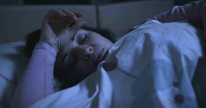 Tired woman napping, cannot fall asleep, shallow sleep. Sleep problems