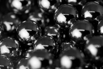 Metal balls with shiny reflections. The balls are arranged next to each other, the structure is...