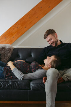 Happy young expecting caucasian couple hanging out at home - cud