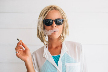 Woman smoking infront of white background
