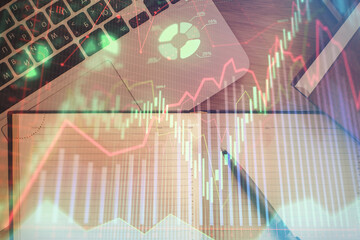 Stock market chart and top view computer on the table background. Double exposure. Concept of financial analysis.