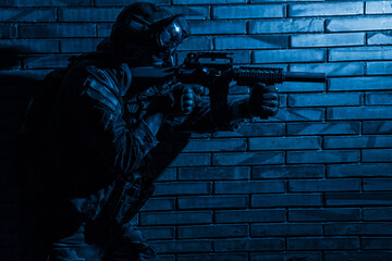 Army soldier, counter terrorist squad fighter in camouflage uniform, load carrier and goggles on...