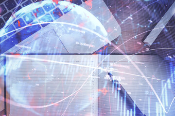 Stock market graph and top view computer on the table background. Multi exposure. Concept of financial education.