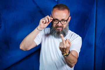 Adult male mentor, director, businessman in glasses and a suit studying documents while sitting at the table. Working day concept